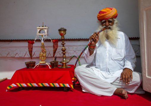 Portrait of a rajasthani guard smoking in the fort, Rajasthan, Jodhpur, India