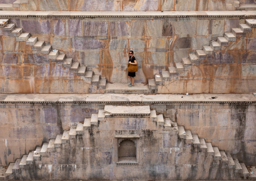 Western tourist in Nagar sagar Kund stepwell, Rajasthan, Bundi, India