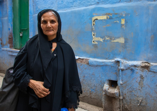 Portrait of a rajasthani woman in traditional black sari, Rajasthan, Jodhpur, India