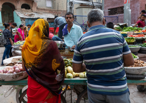 Indian man selling vegetables in a market, Rajasthan, Bikaner, India