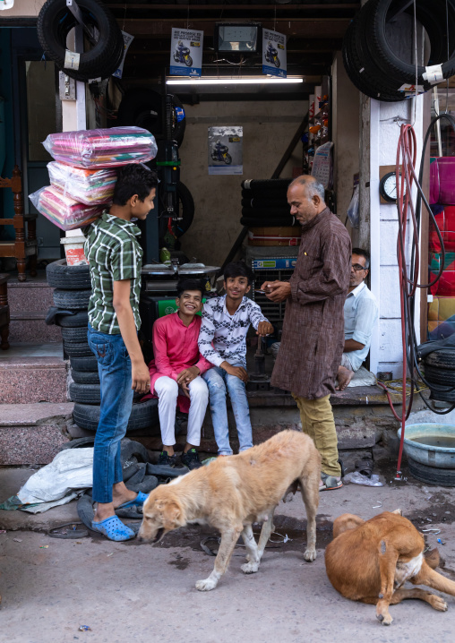 Indian people chatting in front of shops in the street, Rajasthan, Jodhpur, India