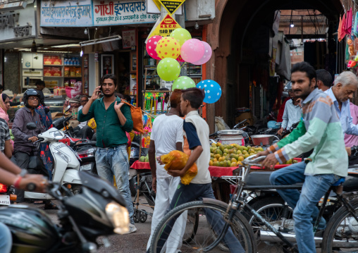 Indian riders ride motorbikes on busy road, Rajasthan, Bikaner, India