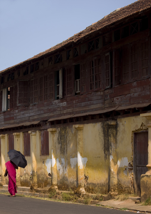 Woman In Sari Holding An Umbrella Passing-by A Street During A Strike In Fort Kochi, India