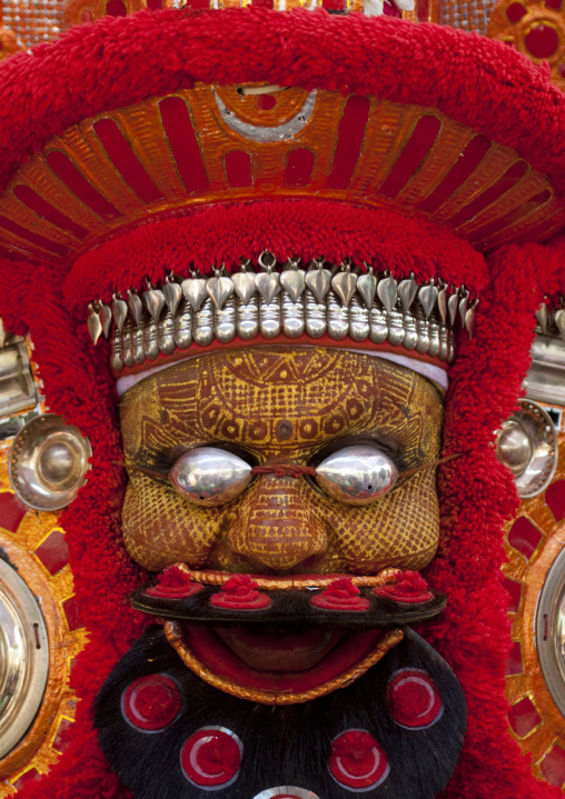 Man Dressed For Theyyam Ceremony With Traditional Painting On His Face And A Mask On His Eyes, Thalassery, India