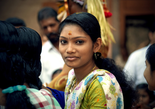 Young Woman With Traditional Painting On Her Forehead In The Audience During Theyyam Ceremony, Thalassery, India