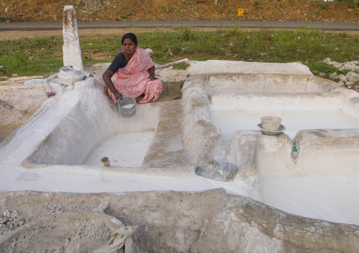 Squatting Woman Drawing Lime With A Bucket, Madurai, India