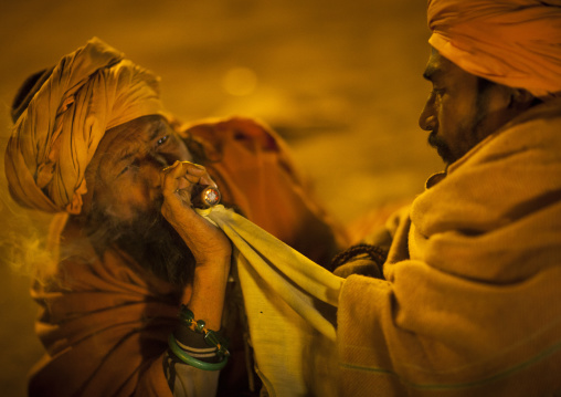 A Naga Sadhu Smoking Pot, Maha Kumbh Mela, Allahabad, India