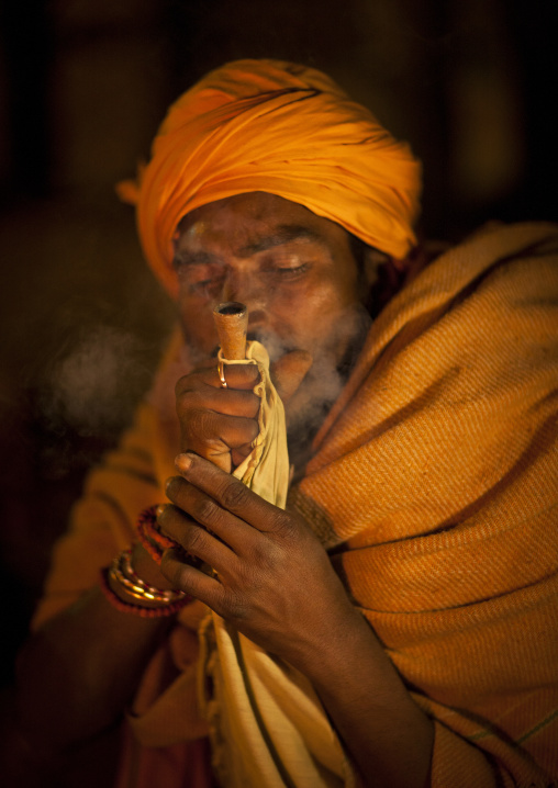 A Naga Sadhu Smoking Pot, Maha Kumbh Mela, Allahabad, India