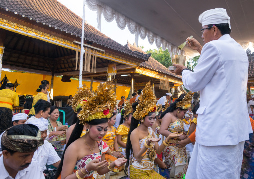 Priest Blessing With Water Some Teenagers In Traditional  Costumes  Before A Tooth Filing Ceremony