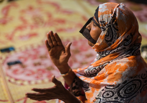 woman with traditional burqa mask during a zar ceremony, Qeshm Island, Salakh, Iran