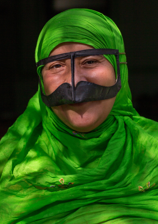 a bandari woman wearing a traditional mask called the burqa with a moustache shape, Qeshm Island, Salakh, Iran