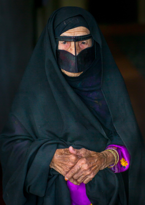 an old bandari woman wearing a traditional mask called the burqa, Qeshm Island, Salakh, Iran