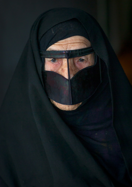 an old bandari woman wearing a traditional mask called the burqa, Qeshm Island, Salakh, Iran