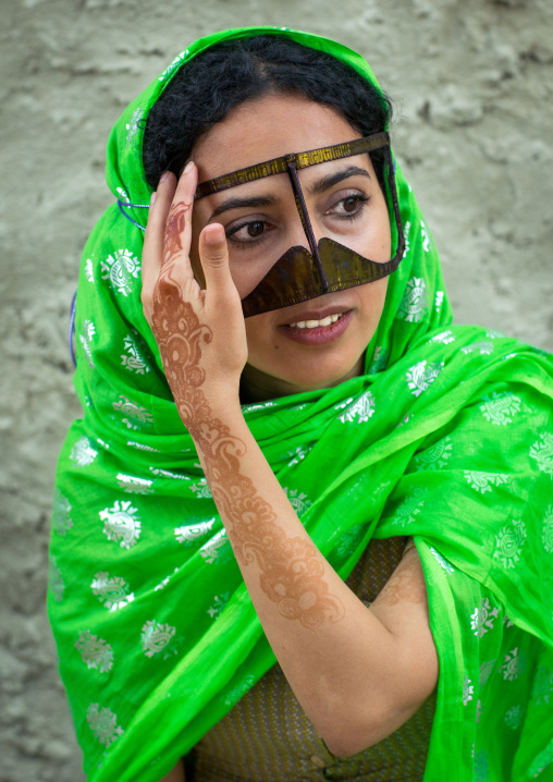 a bandari woman wearing a traditional mask called the burqa with a moustache shape, Qeshm Island, Salakh, Iran