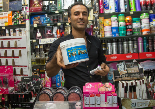 vendor showing a fat face pot in a beauty shop in the bazaar, Hormozgan, Bandar Abbas, Iran