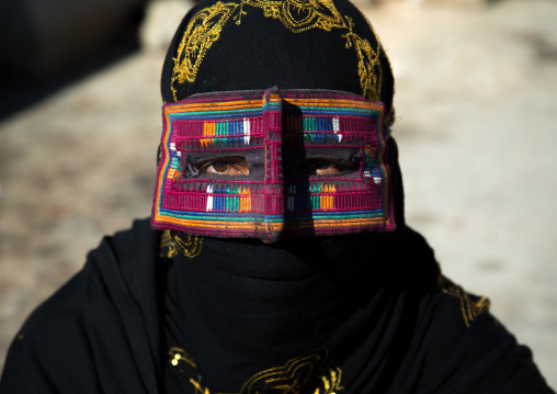 a bandari woman wearing the traditional mask called the burqa on a market, Hormozgan, Bandar Abbas, Iran