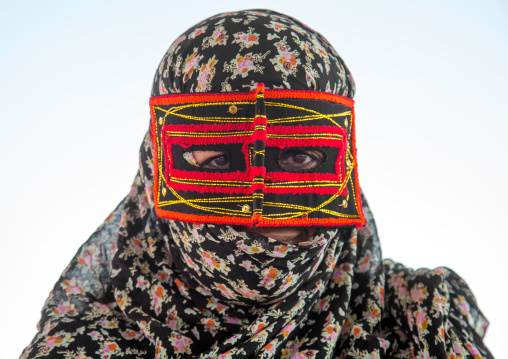 a bandari woman wearing the traditional mask called the burqa on a market, Hormozgan, Bandar Abbas, Iran