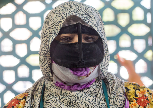 a bandari woman wearing the traditional mask called the burqa on a market, Hormozgan, Bandar Abbas, Iran