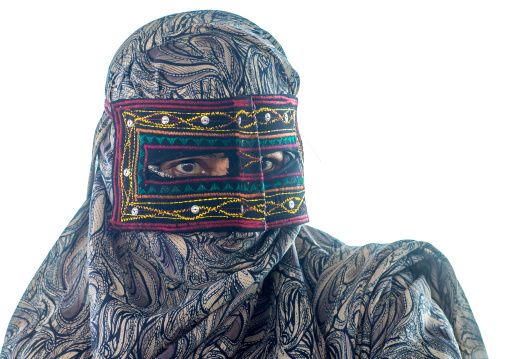 a bandari woman wearing the traditional mask called the burqa on a market, Hormozgan, Bandar Abbas, Iran