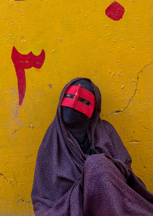 a bandari woman wearing the traditional mask called the burqa on a market, Hormozgan, Bandar Abbas, Iran