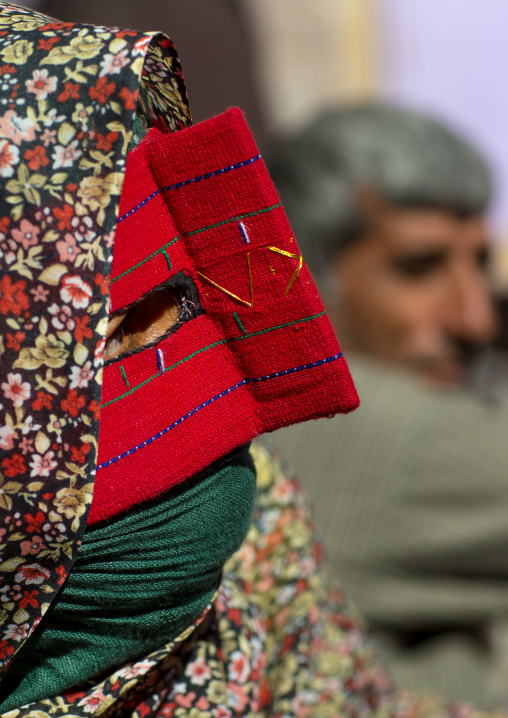 a bandari woman wearing the traditional mask called the burqa on a market, Hormozgan, Bandar Abbas, Iran