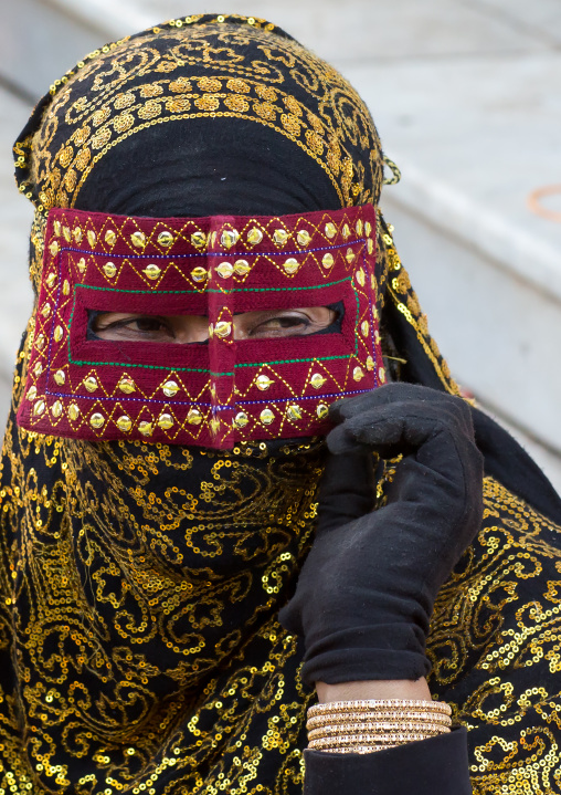 a bandari woman wearing the traditional mask called the burqa on a market, Hormozgan, Bandar Abbas, Iran