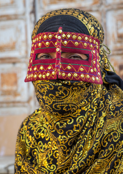 a bandari woman wearing the traditional mask called the burqa on a market, Hormozgan, Bandar Abbas, Iran