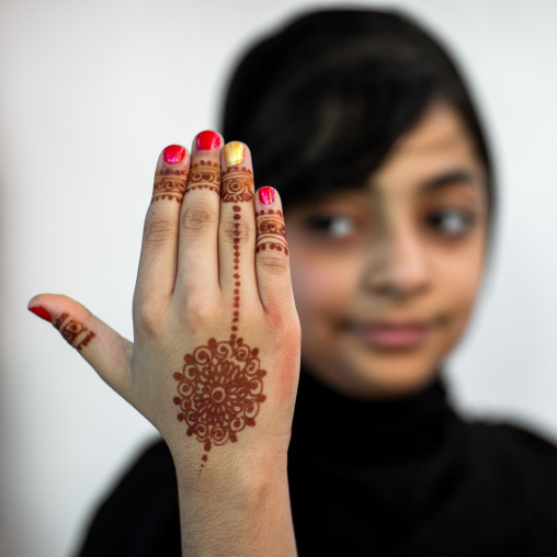 portrait of a young girl with henna tattooed hands in traditional bandari clothing during a wedding ceremony, Hormozgan, Bandar-e Kong, Iran