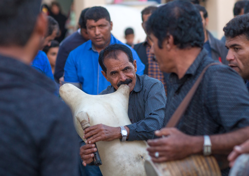 men dancing and playing sheep skin pipe bag during a wedding ceremony, Hormozgan, Kushkenar, Iran