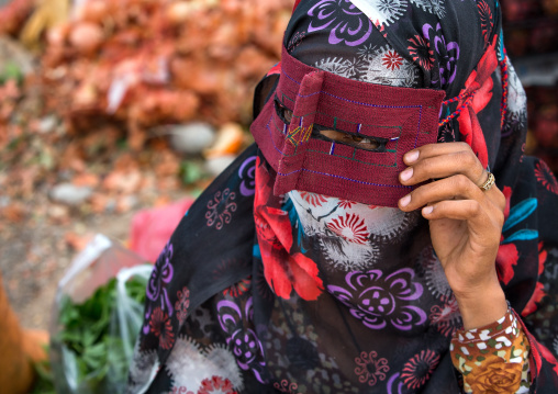 a bandari woman wearing a traditional mask called the burqa at panjshambe bazar thursday market, Hormozgan, Minab, Iran