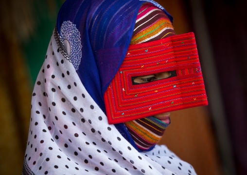 a bandari woman wearing a traditional mask called the burqa at panjshambe bazar thursday market, Hormozgan, Minab, Iran