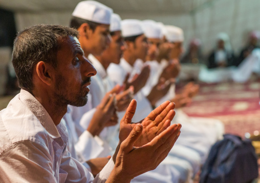 men praying during a wedding ceremony, Qeshm Island, Tabl , Iran