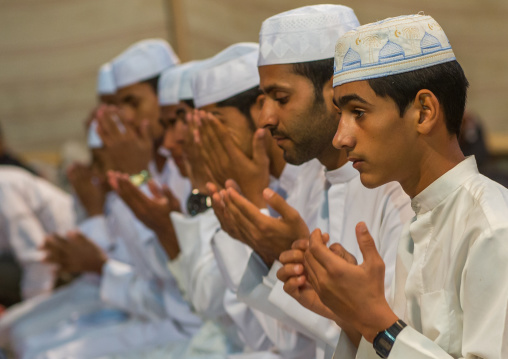 men praying during a wedding ceremony, Qeshm Island, Tabl , Iran