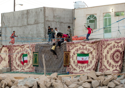 children playing in carpets after a wedding, Qeshm Island, Salakh, Iran