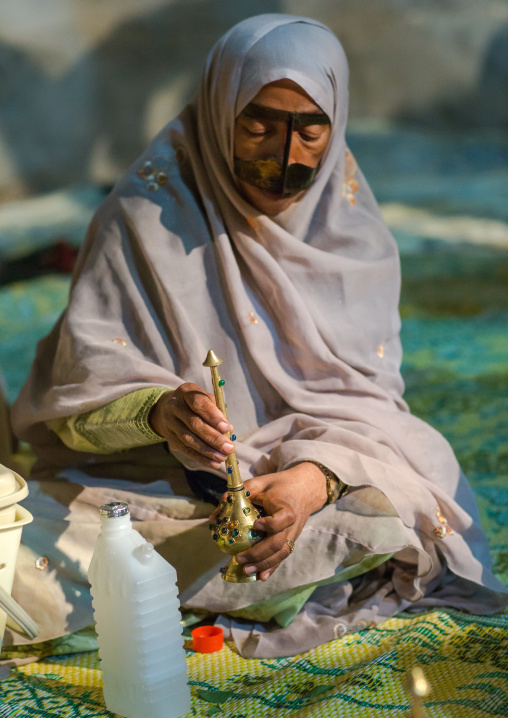 woman with traditional burqa mask during a zar ceremony, Qeshm Island, Salakh, Iran