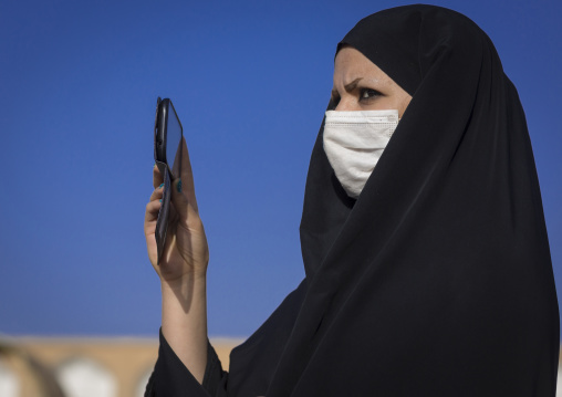 Veiled woman taking pictures with her mobile phone, Isfahan province, Isfahan, Iran