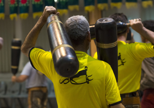 Men wielding wooden clubs during the traditional sport of zurkhaneh, Isfahan province, Kashan, Iran