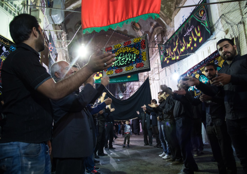 Iranian shiite muslim men beating themselves with iron chains to commemorate the martyrdom anniversary of Hussein, Isfahan Province, Isfahan, Iran