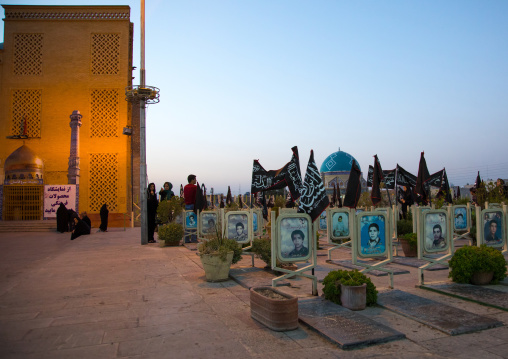 Families praying on the tomb of their sons killed in the Iran Iraq war in the Rose garden of martyrs cemetery, Isfahan Province, Isfahan, Iran