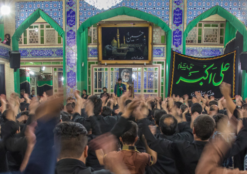 Iranian shiite muslim mourners chanting  during Muharram inside a hosseinieh, Yazd Province, Yazd, Iran