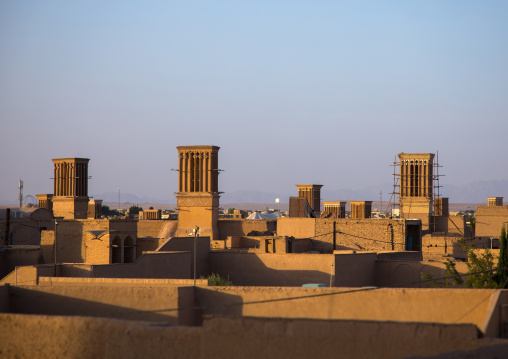 View of the city with traditional wind catchers and mosques at dusk, Yazd Province, Yazd, Iran