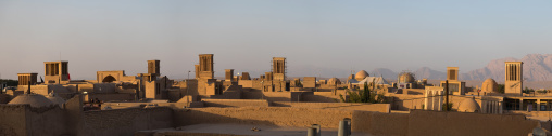 View of the city with traditional wind catchers and mosques at dusk, Yazd Province, Yazd, Iran