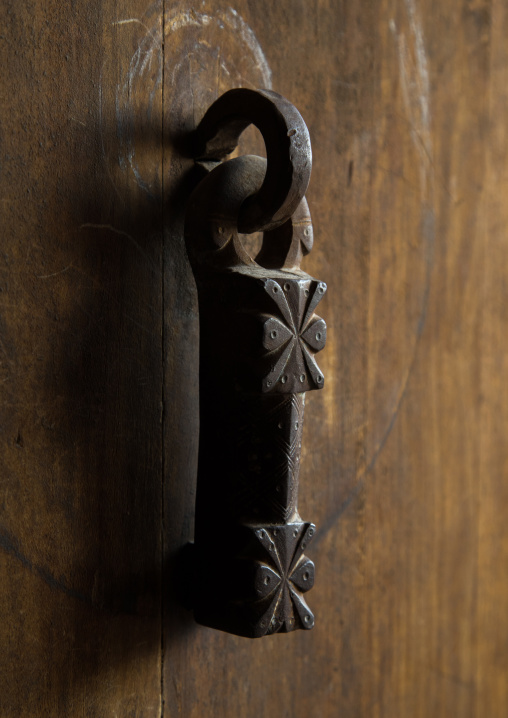 Ancient male doorknocker on a wooden door, Isfahan Province, Ardestan, Iran