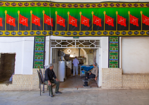 Men in a bakery decorated for Muharram, Isfahan Province, Kashan, Iran