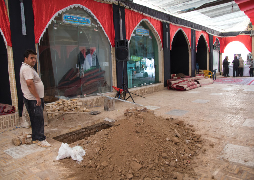 Man digging a hole in Hassan Ibn Musa Ibn Jafar to welcome a new body, Isfahan Province, Kashan, Iran