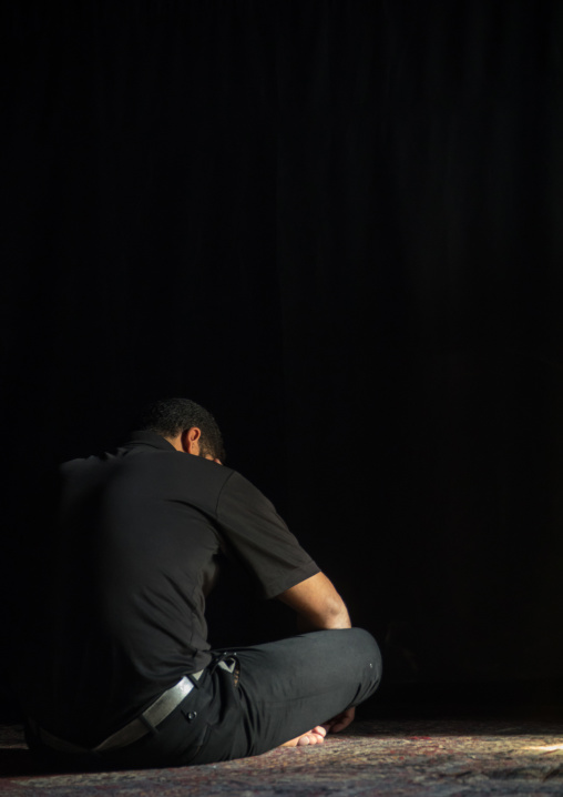 Iranian shiite muslim man praying in a hosseinieh, Isfahan Province, Kashan, Iran