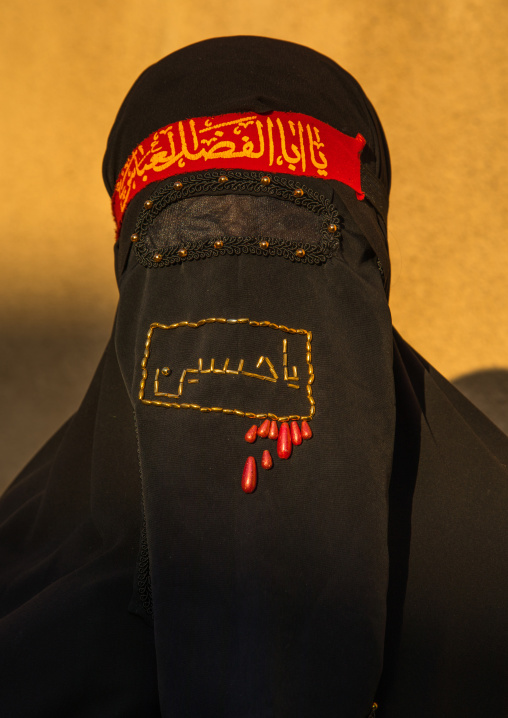 Portrait of an iranian shiite muslim woman with her face hidden by a veil mourning Imam Hussein on Tasua during the Chehel Manbar ceremony one day before Ashura, Lorestan Province, Khorramaba