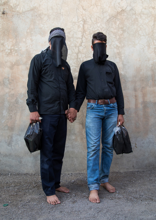 Portrait of iranian shiite muslim men with their faces hidden by a veil mourning Imam Hussein on Tasua during the Chehel Manbar ceremony one day before Ashura, Lorestan Province, Khorramabad,