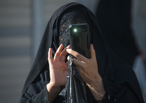 Iranian woman taking pictures with a mobile phone, Lorestan Province, Khorramabad, Iran