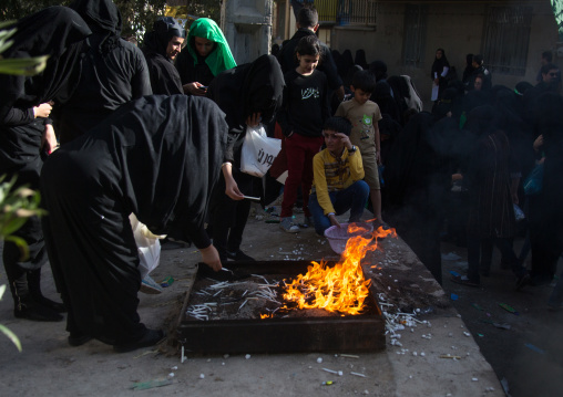 Iranian women light candles and put sugar cubes during Chehel Manbar festival on Tasua to commemorate the martyrdom anniversary of Hussein, Lorestan Province, Khorramabad, Iran